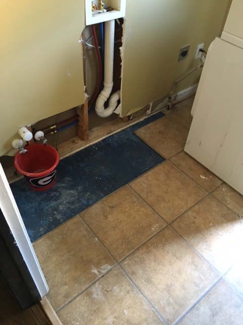 floor and wall of laundry room after flooding