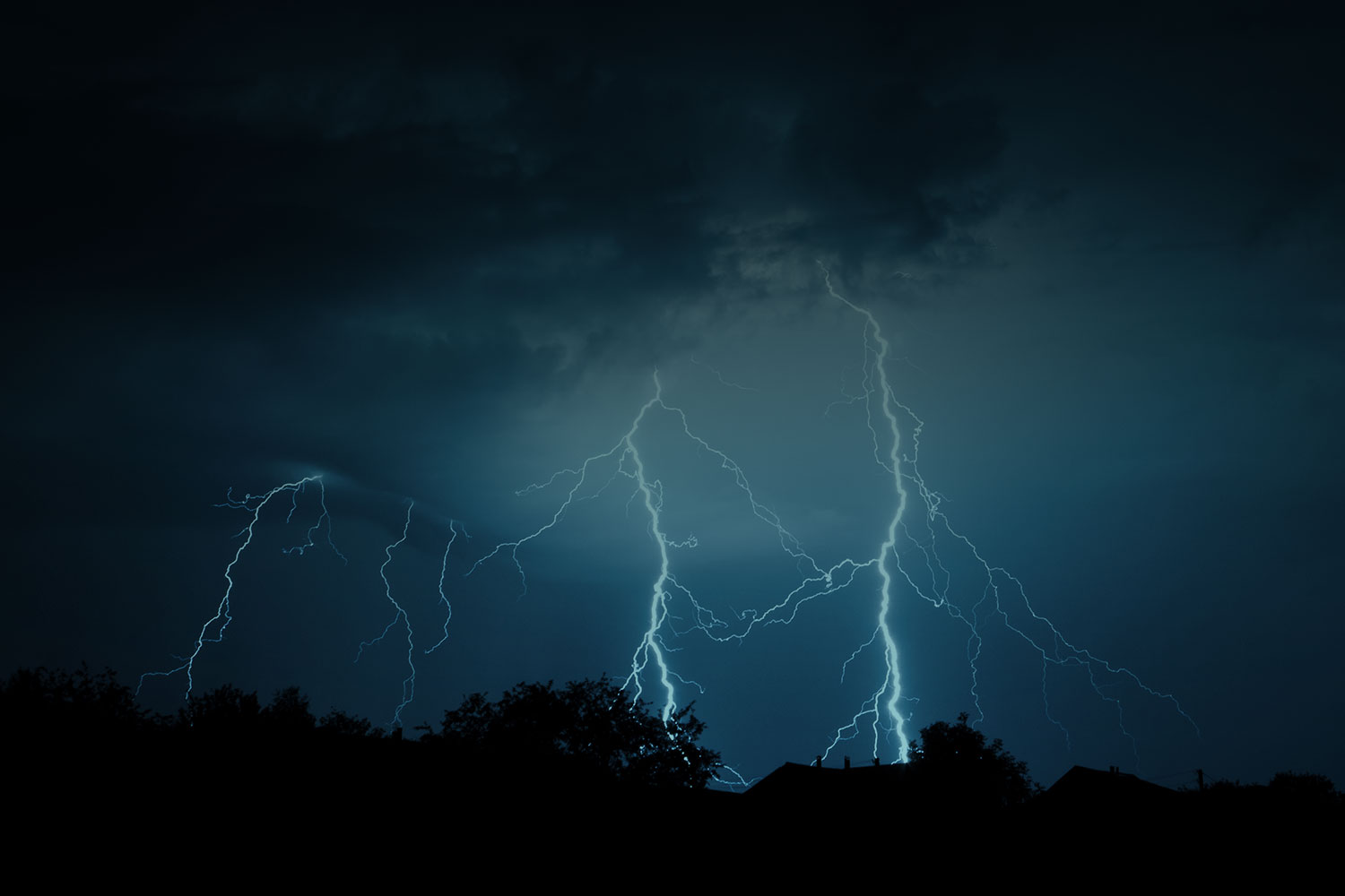 night sky with lightening bolts going from sky to ground