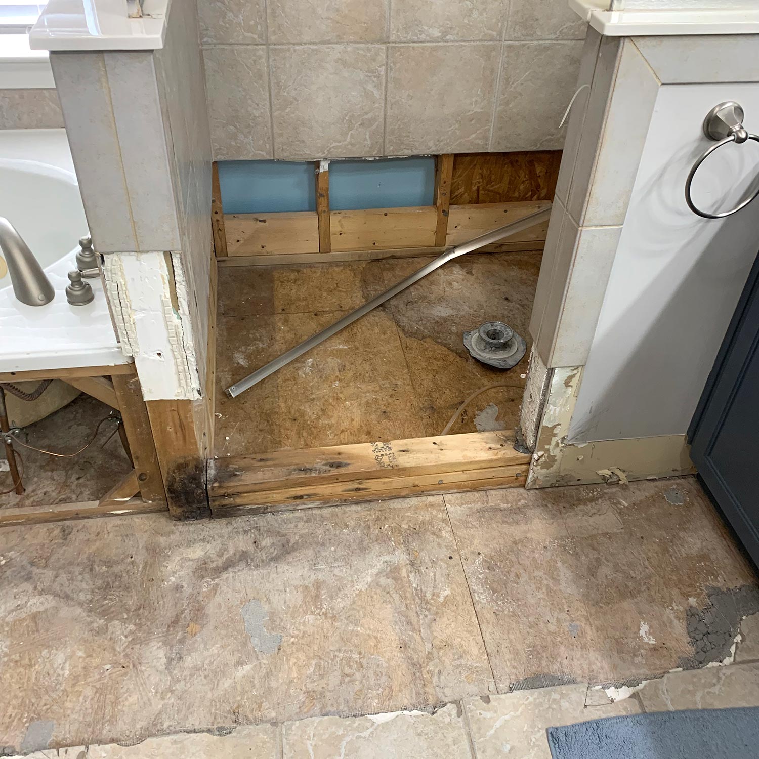 close up of shower, tub & bathroom floor after water damage