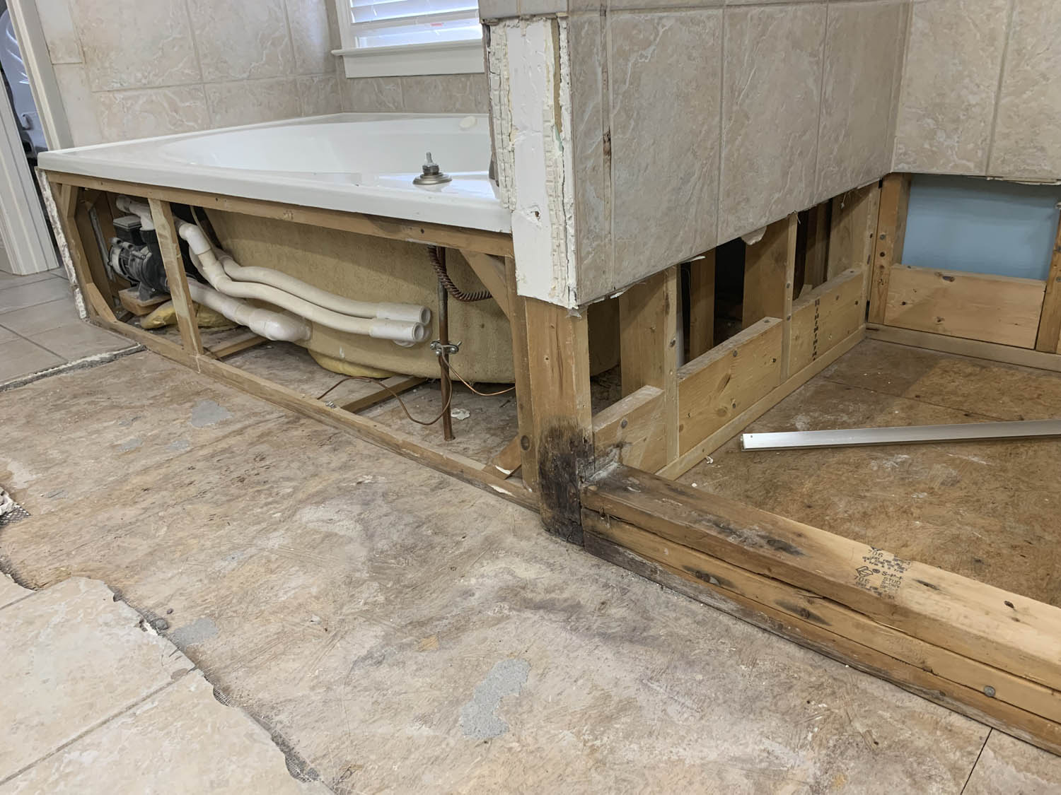 close up of shower, tub & bathroom floor after water damage