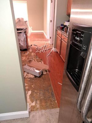 water damaged floor in kitchen after flooring has been taken up